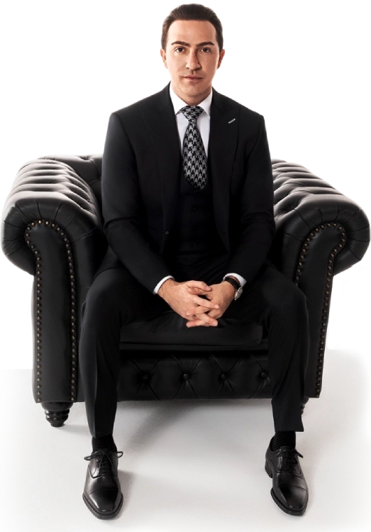 Blake Friedman smiling with his arms crossed