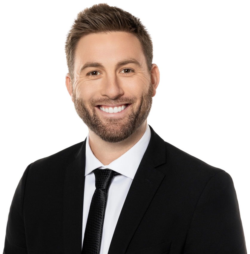 Blake Friedman smiling with his arms crossed